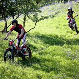 a man riding a motorcycle in a field