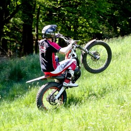 a man riding a motorcycle in a field