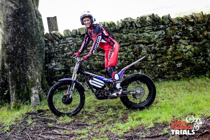 a man riding a motorcycle down a dirt road