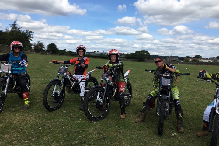 a group of people standing around a motorcycle