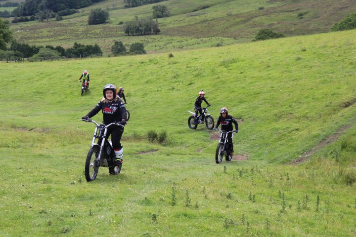 a group of people riding on top of a lush green field