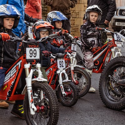 a group of people riding on the back of a motorcycle