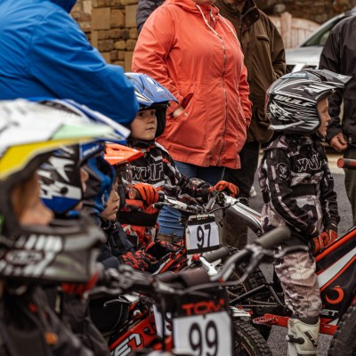 a group of people standing around a motorcycle