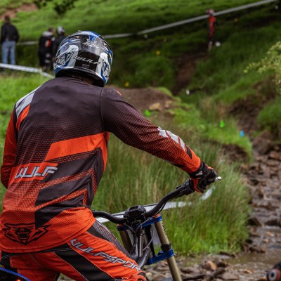 a person riding a bike down a dirt road