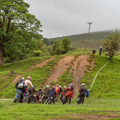 a group of people riding on top of a lush green field