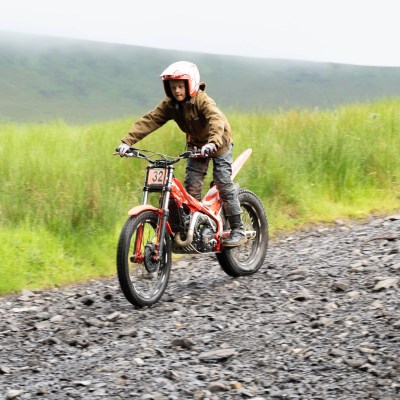 a man riding a bike down a dirt road