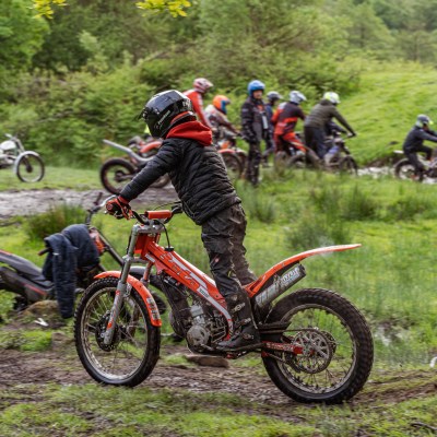 a man riding a bicycle on a dirt field