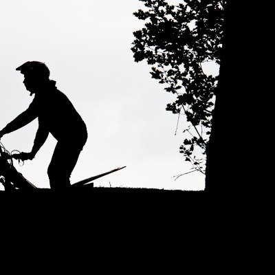 a man riding a skateboard up the side of a hill