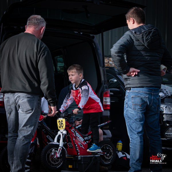a group of people standing around a motorcycle