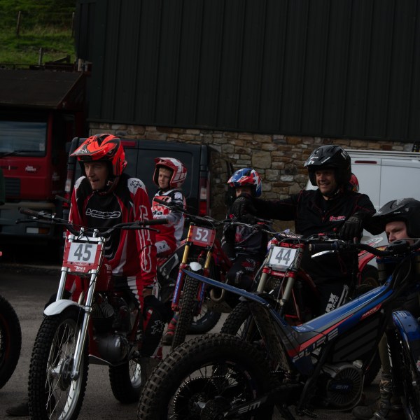 a group of people sitting on a motorcycle