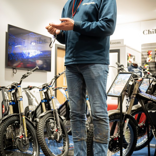 a man standing next to a bicycle