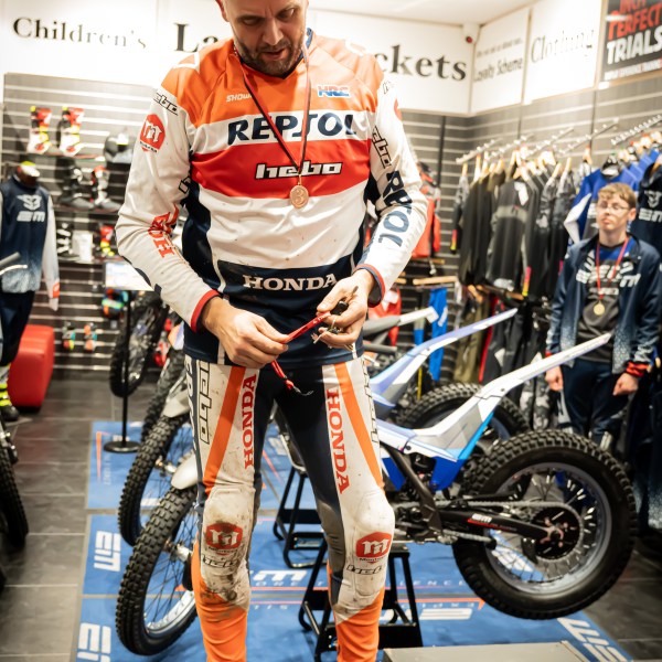 a man standing next to a motorcycle