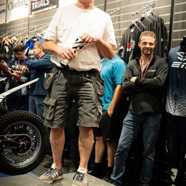 a group of people standing in front of a crowd posing for the camera